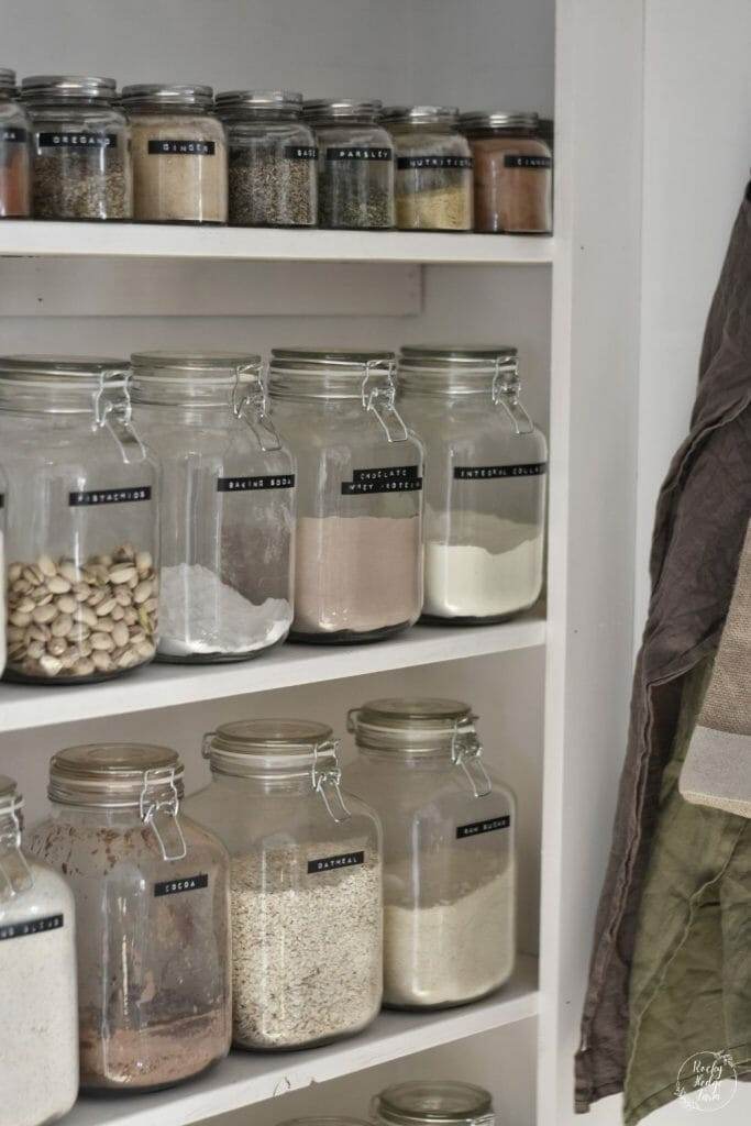 Neat and tidy pantry using glass jars and wooden shelving.