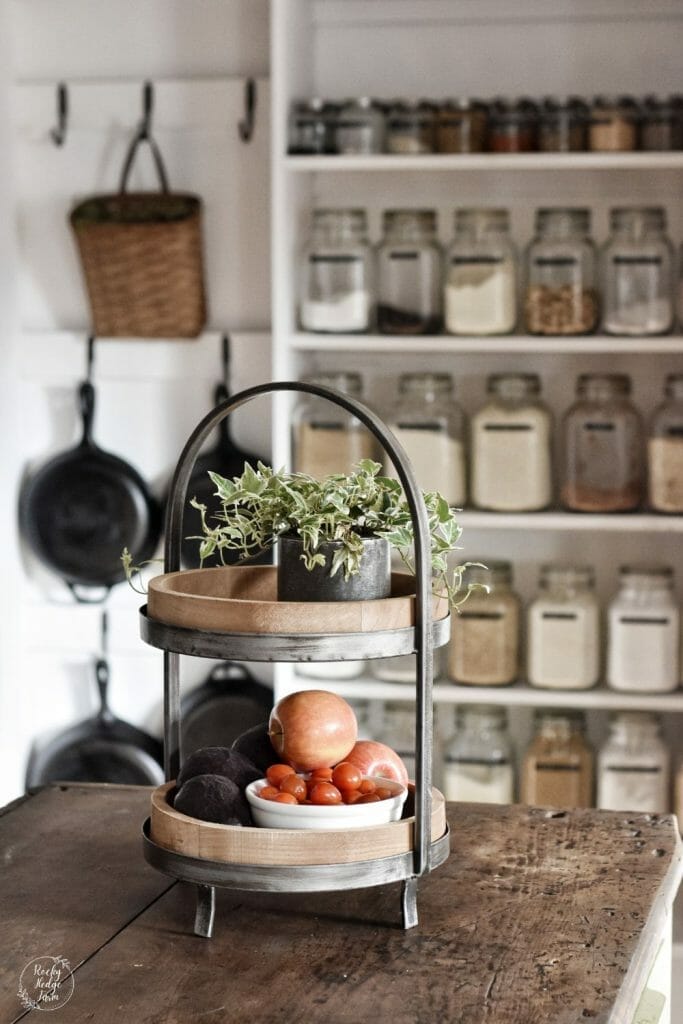 Small pantry with clear glass jar storage and labeled contents.