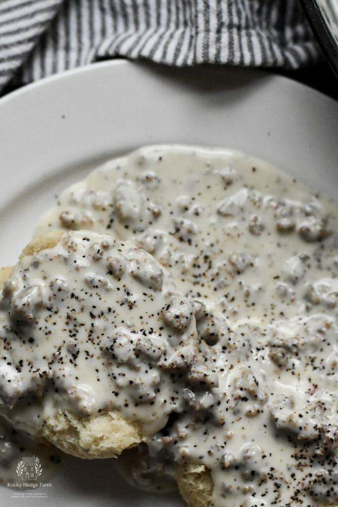 flaky buttermilk biscuits smothered in creamy sausage gravy with heavy cream.