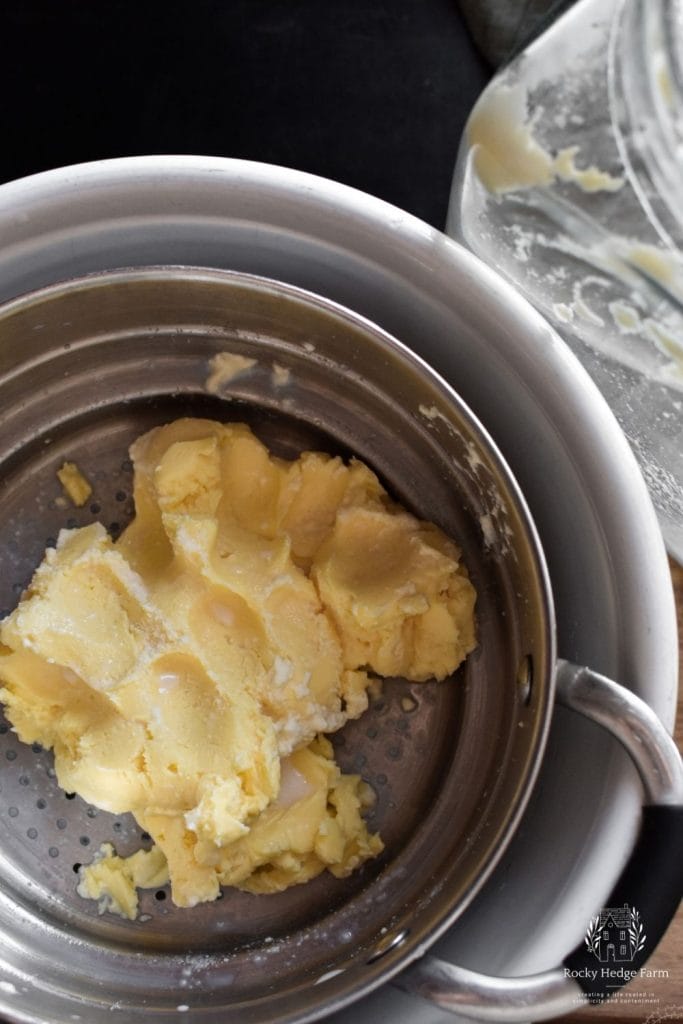 A colander that has freshly churned homemade butter in it to drain away the buttermilk.