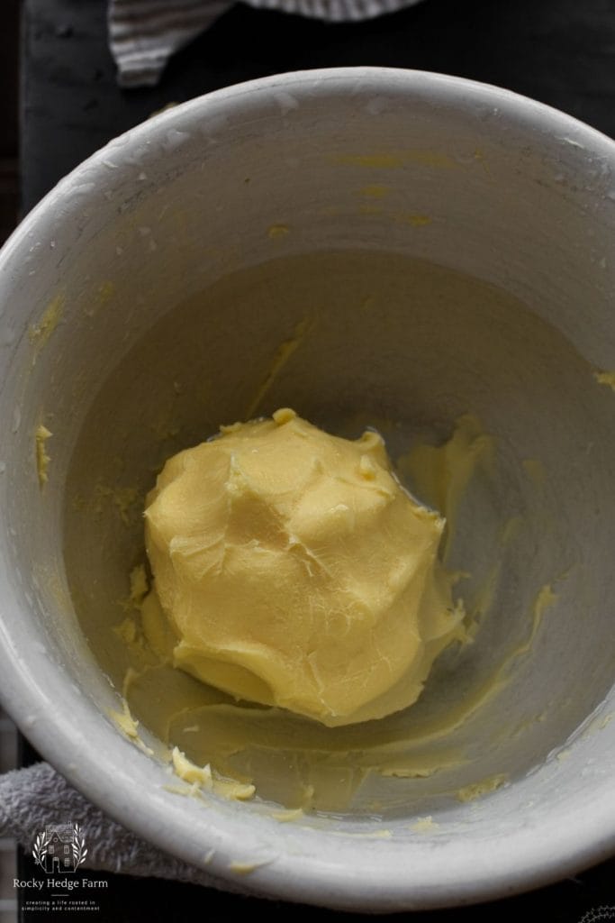 freshly churned butter sitting in a bowl of water to be rinsed of all the buttermilk