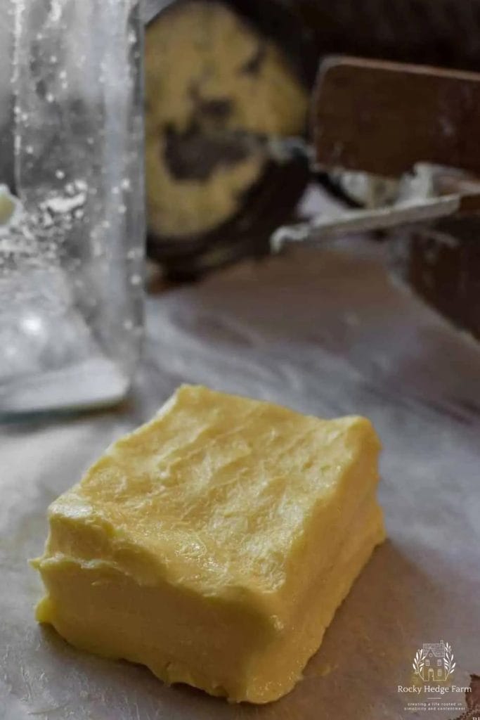 a large square of butter that was churned by hand sitting on the countertop