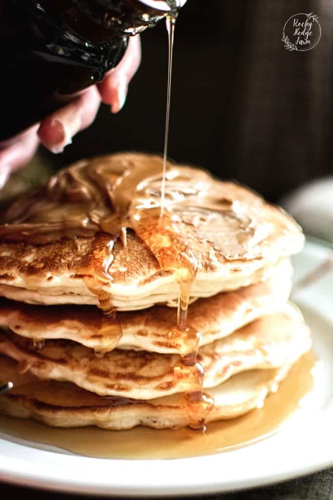 Pancakes on a Plate Drizzled with Maple Syrup