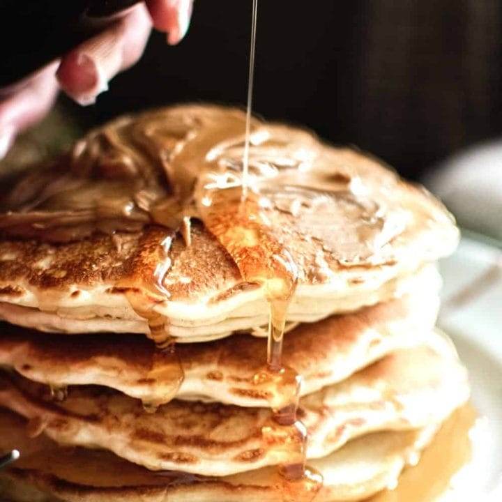 Pancakes on a Plate Drizzled with Maple Syrup