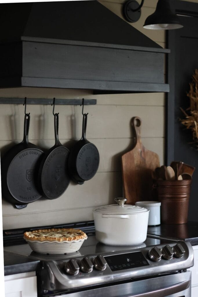 hanging cast iron skillets on a wall. 