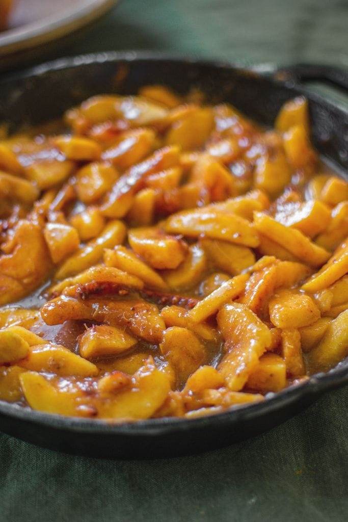 Peach crisp filling in a cast iron skillet