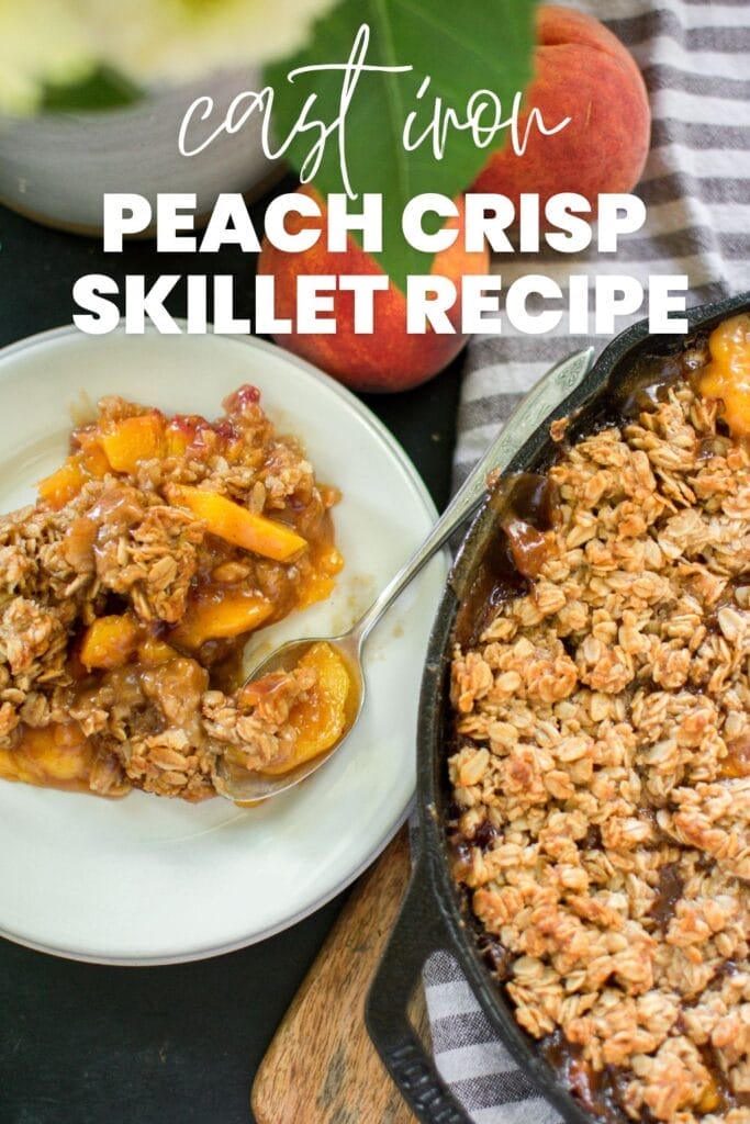 A cast iron skillet filled with a peach crisp A white plate and a spoon are beside the skillet
