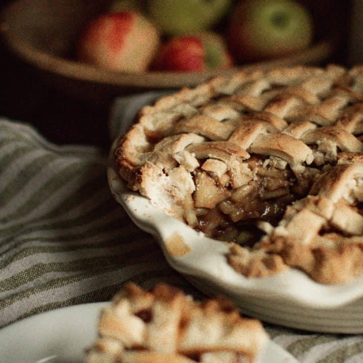 Homemade slice of apple pie with maple syrup