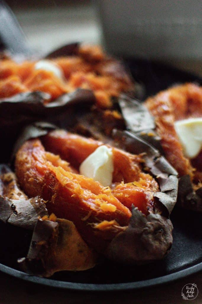 Baked Sweet Potato with butter on a cast iron skillet