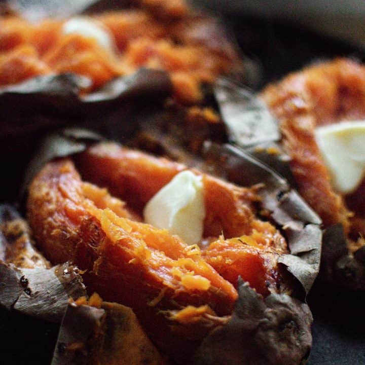 Baked Sweet Potato with butter on a cast iron skillet