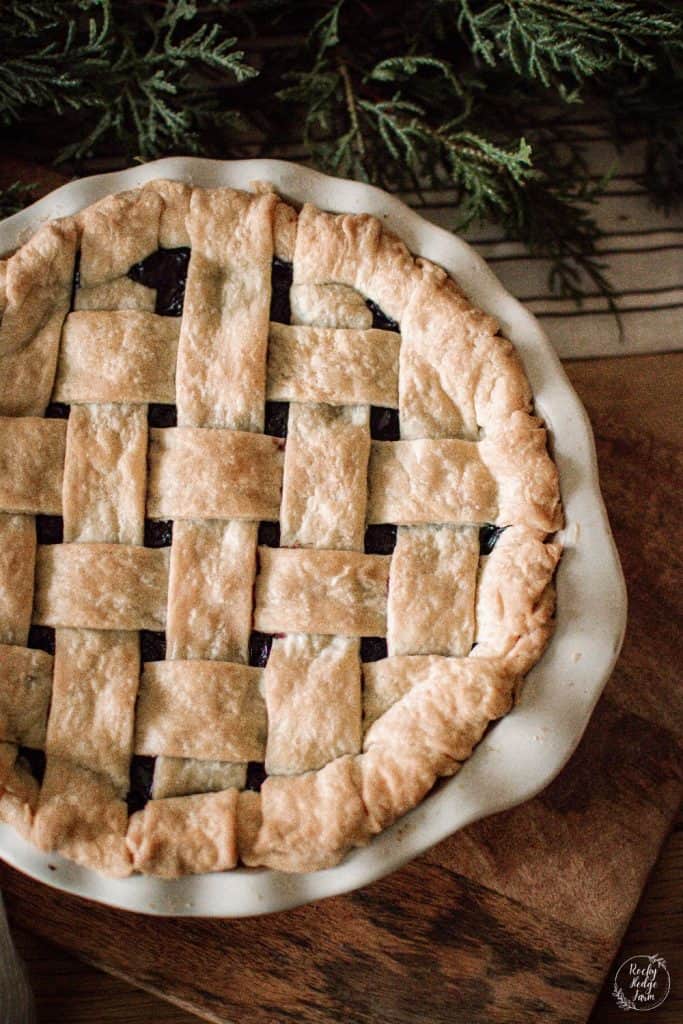 A homemade cherry pie made with frozen cherries sitting on the table.
