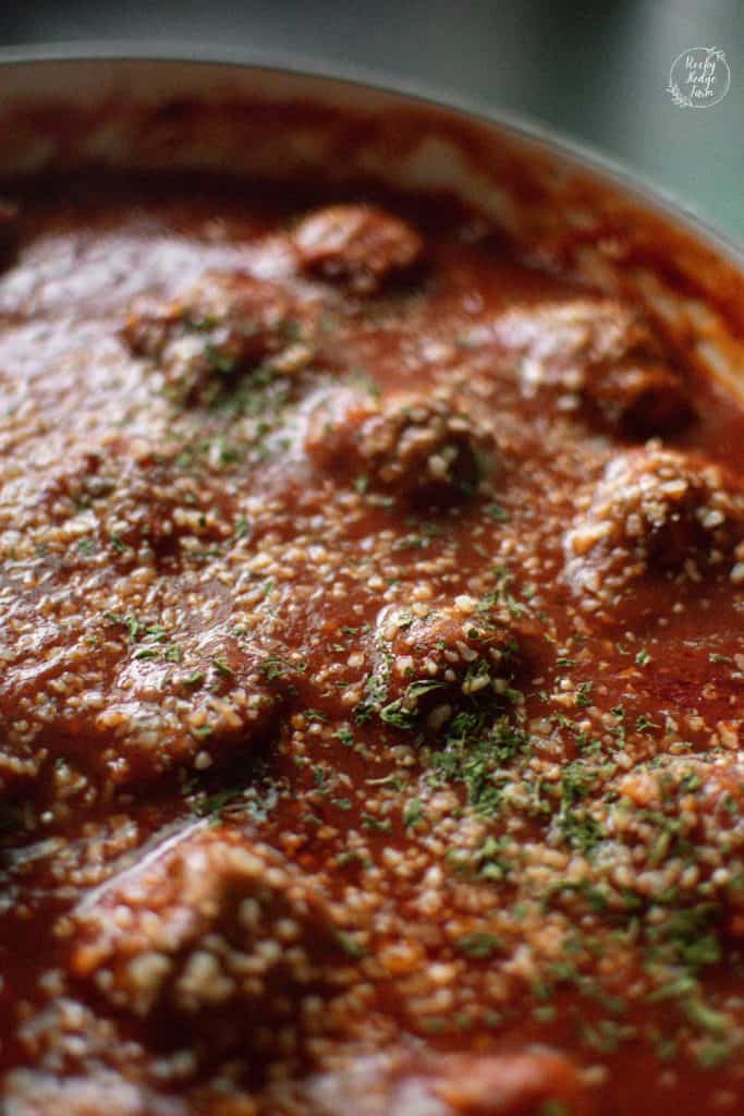 A simmering pan full of easy Italian meatballs. 