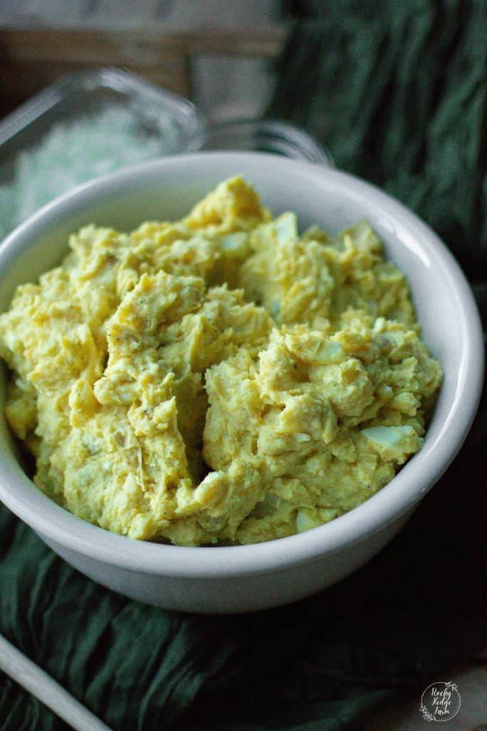 a white ironstone bowl filled with homemade potato salad