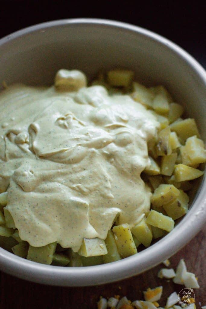 Old Fashioned Potato Salad Dressing being added to a bowl