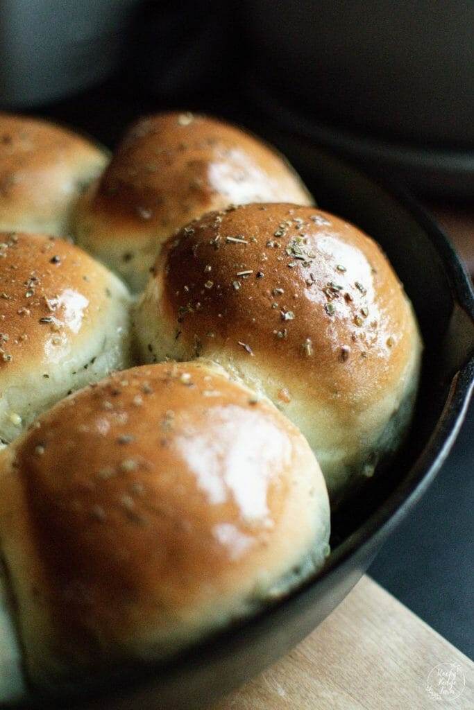 rosemary garlic dinner rolls in a cast iron skillet