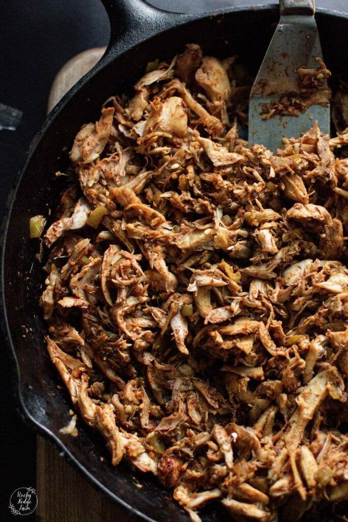 Scrumptious shredded chicken tacos cooking in a cast iron skillet