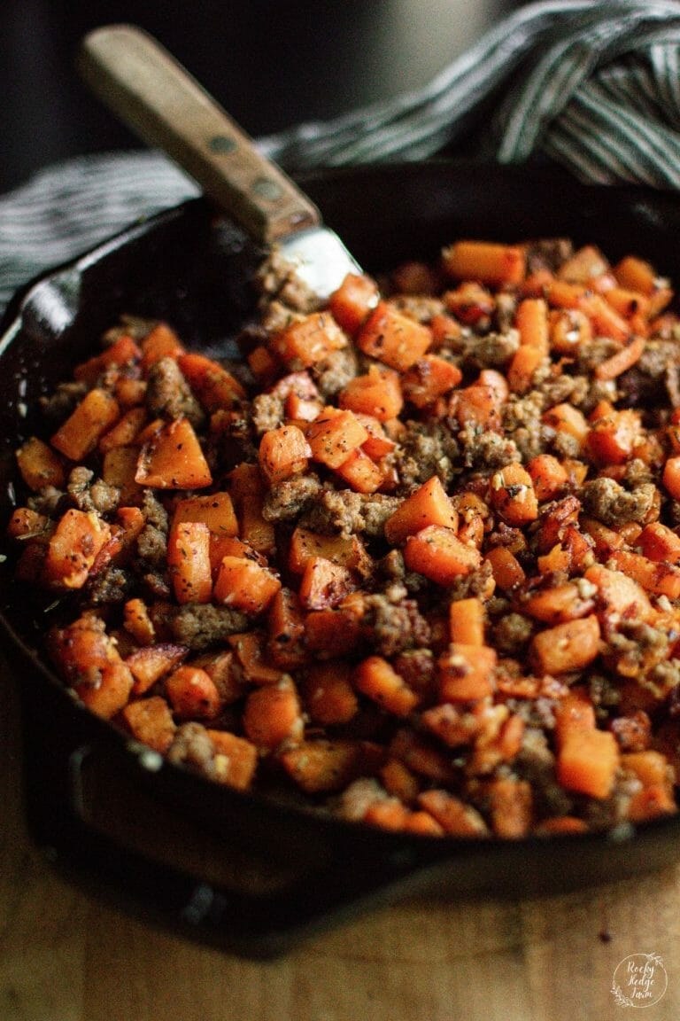 sausage and sweet potato hash in a cast iron skillet