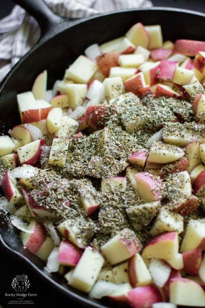 herb seasoning sprinkled on raw potatoes