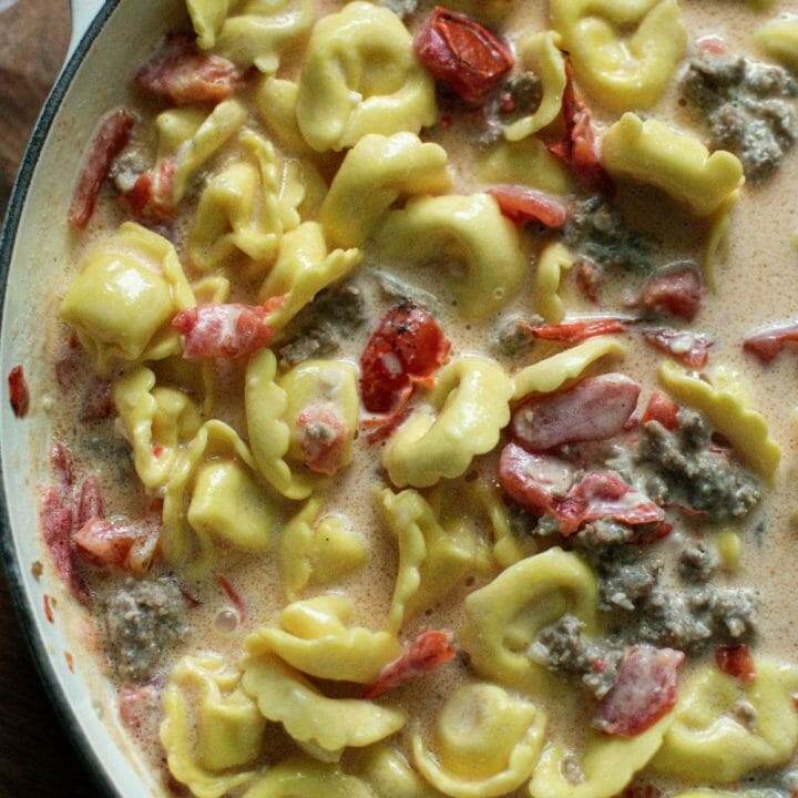 A delicious and easy-to-make skillet dish with creamy tortellini, Italian sausage, and spinach.