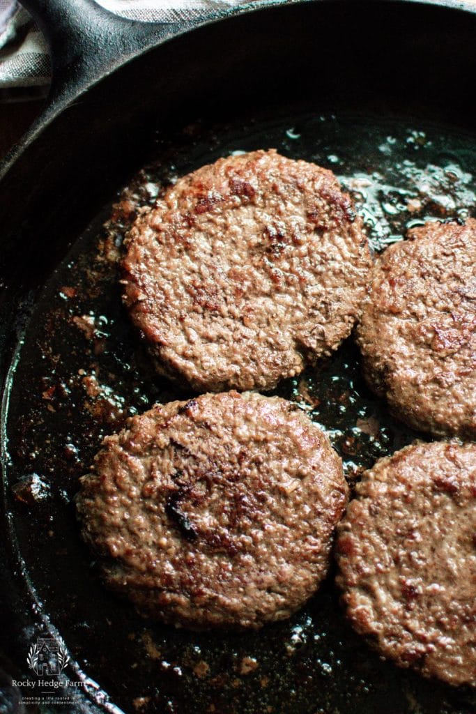 cooked burgers in a cast iron skillet