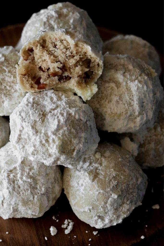 snowball cookies stacked on a platter