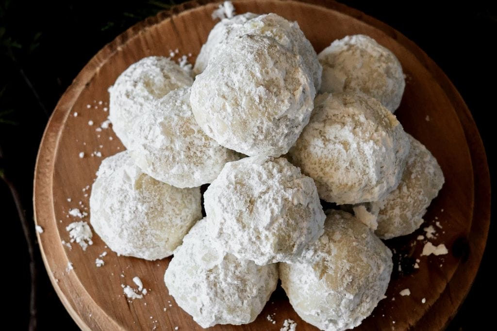 A platter full of snowball cookies with pecans