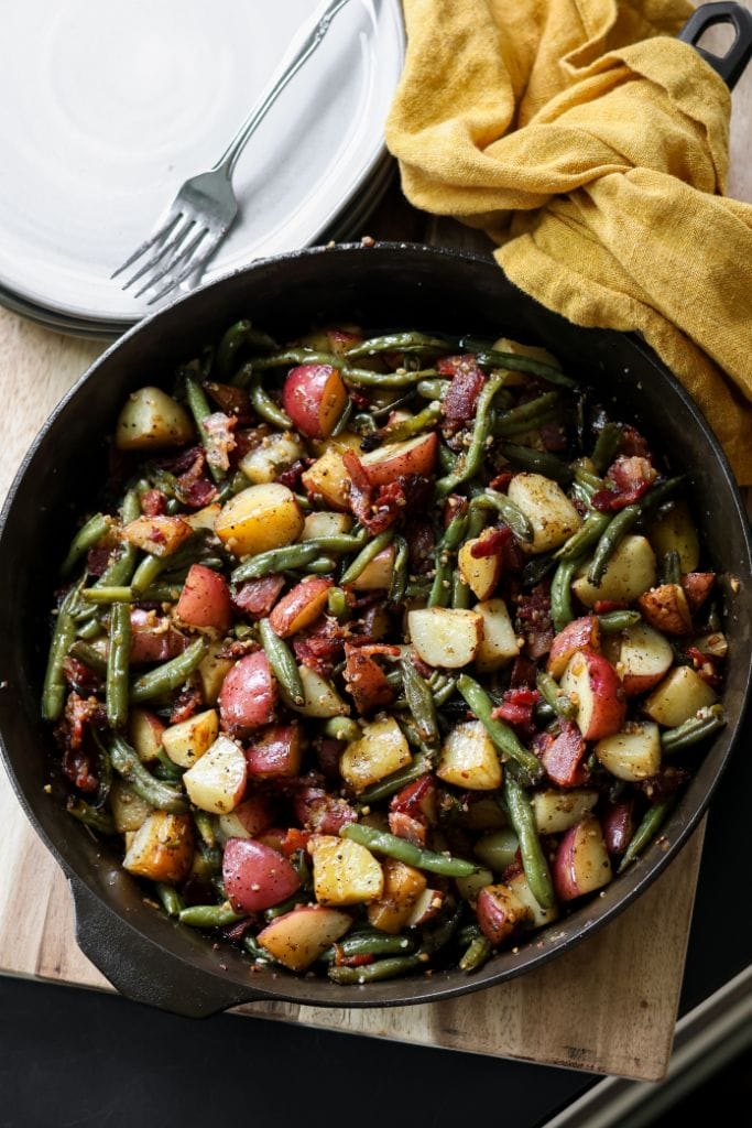 Simple summer side dish: Vibrant green beans and new potatoes in a cast iron skillet.