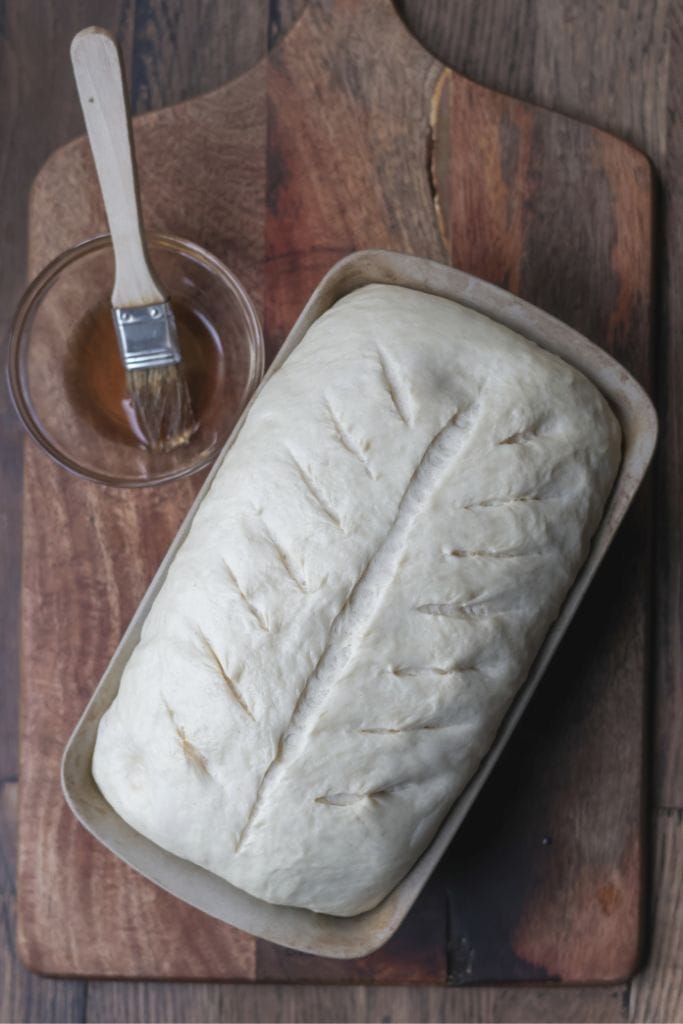 loaf of bread in a loaf pan ready to be baked