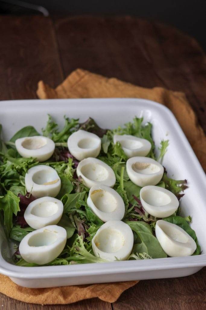 Empty halves of hard-boiled eggs, ready to be filled with a creamy deviled egg mixture.