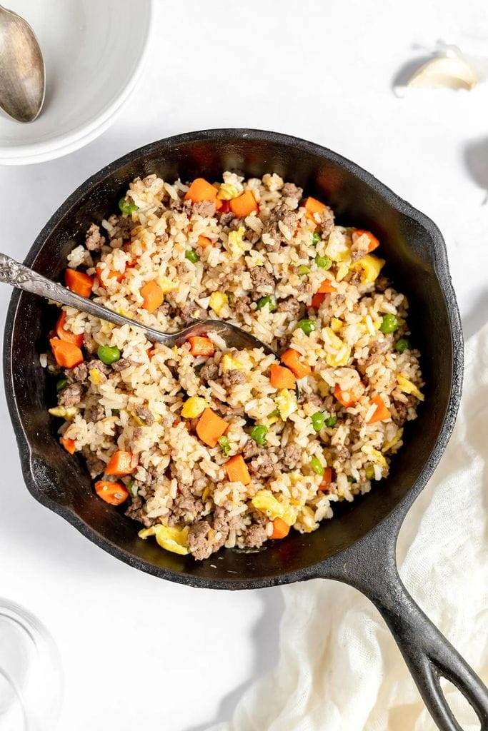 ground beef fried rice in a cast iron skillet