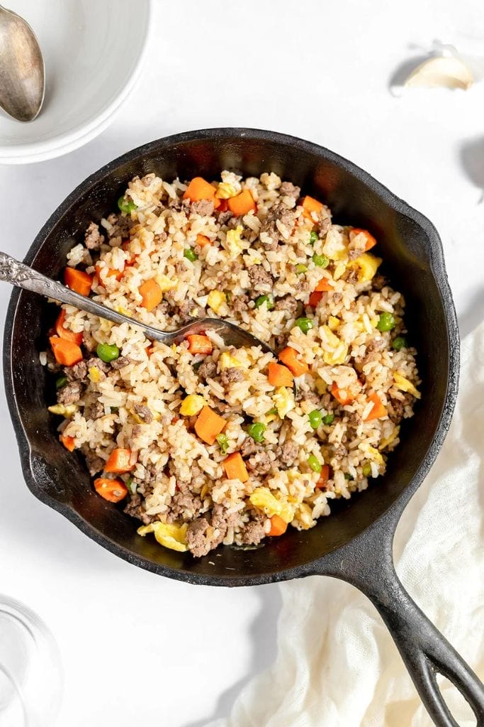 ground beef fried rice in a cast iron skillet