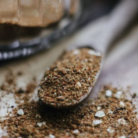 Collection of spices, including chili powder, cumin, and salt, for making taco seasoning at home.