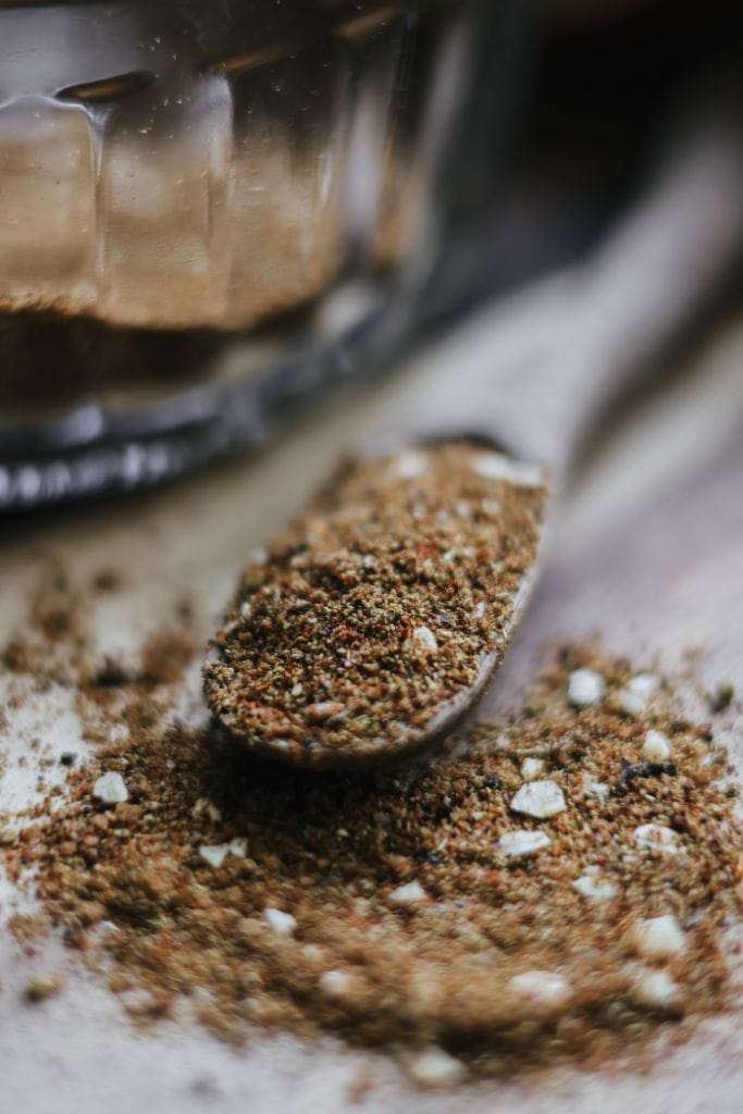 Collection of spices, including chili powder, cumin, and salt, for making taco seasoning at home.