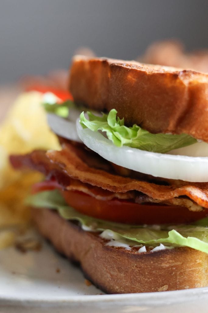 Classic BLT sandwich with crispy bacon, fresh lettuce, juicy tomatoes, and creamy mayonnaise on toasted bread.