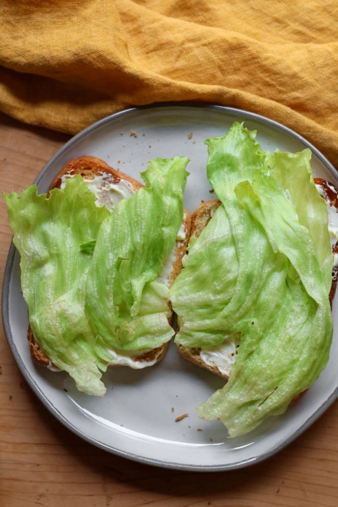 Lettuce on toasted bread for a BLT