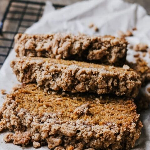 three slices of pumpkin bread with brown sugar streusel