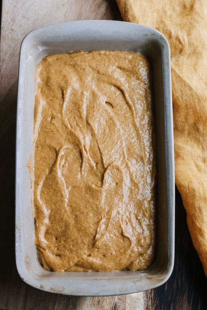 pumpkin bread batter in a loaf pan