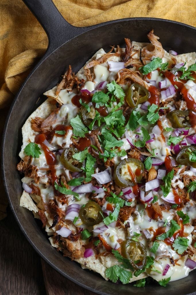 cast iron skilled filled with bbq nachos