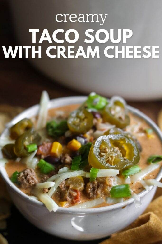 Bowl of creamy taco soup topped with cheese and jalapenos. 