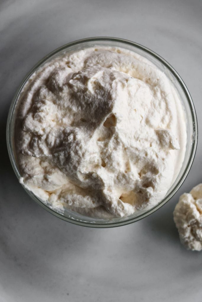 a glass bowl filled with maple vanilla whipped cream