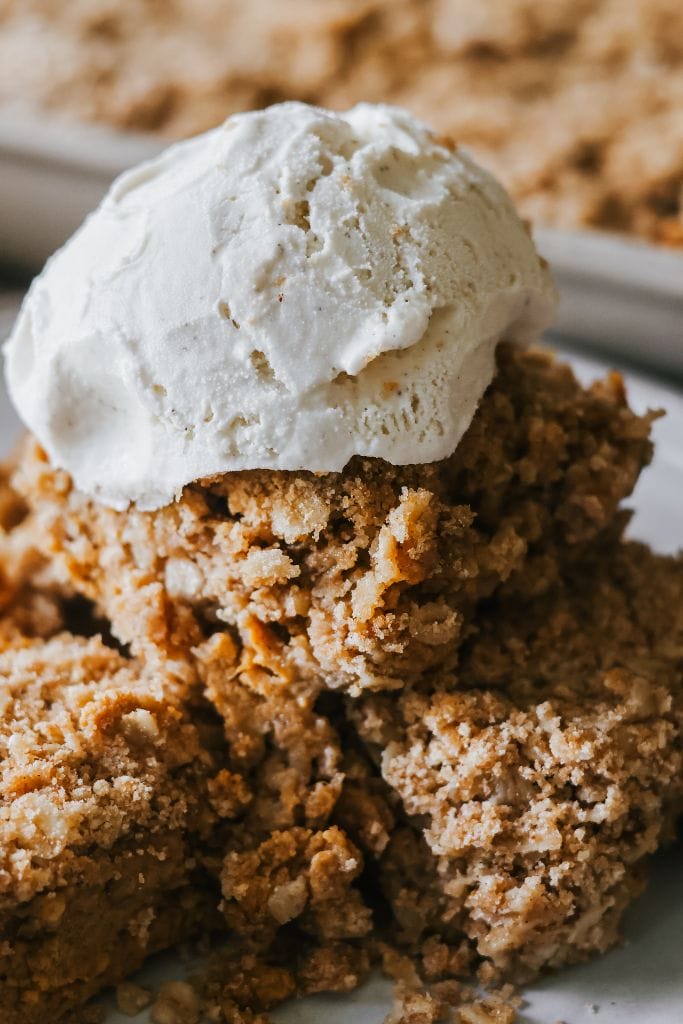 a bowl of pumpkin crisp  topped with vanilla ice cream