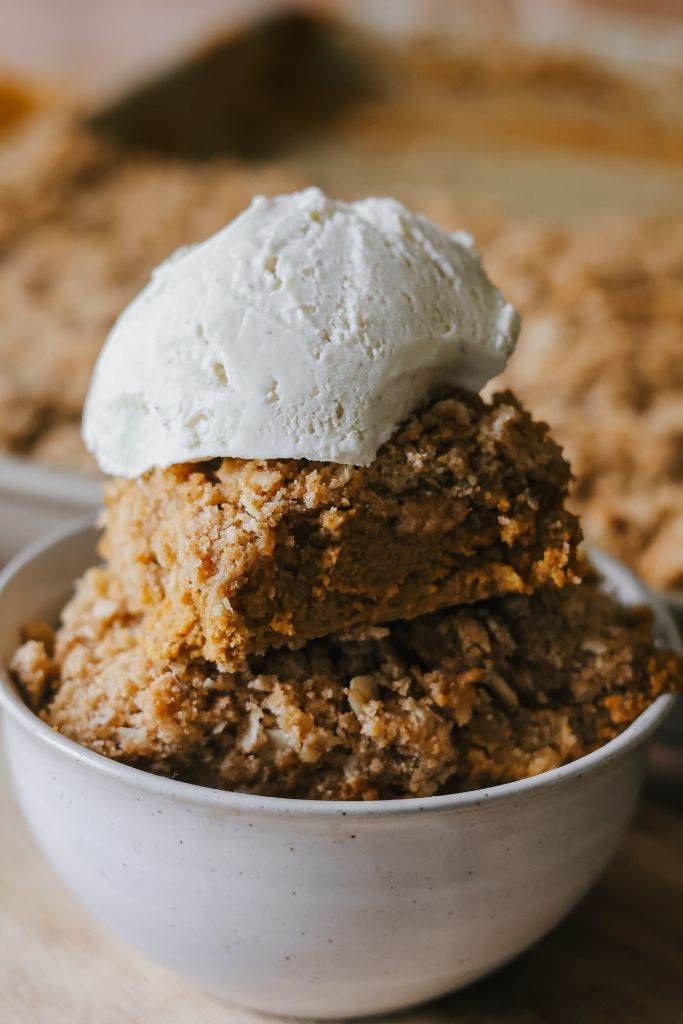 a bowl of pumpkin crisp topped with ice cream