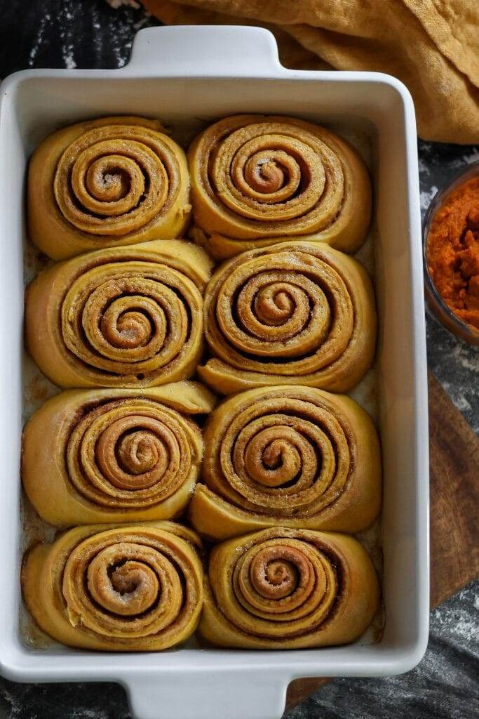 freshly baked pumpkin cinnamon rolls in a pan