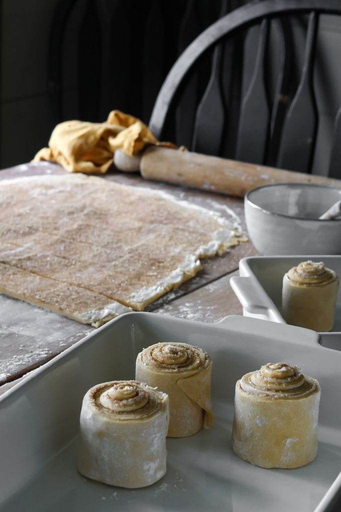 rolled pumpkin cinnamon roll dough in a pan