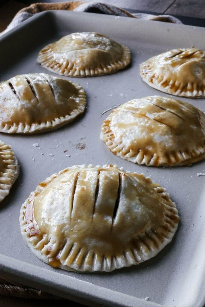 apple hand pie brushed with maple syrup before baking