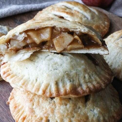 Close-up of a perfectly golden, flaky crust on a homemade apple hand pie, showing off the layers of buttery goodness