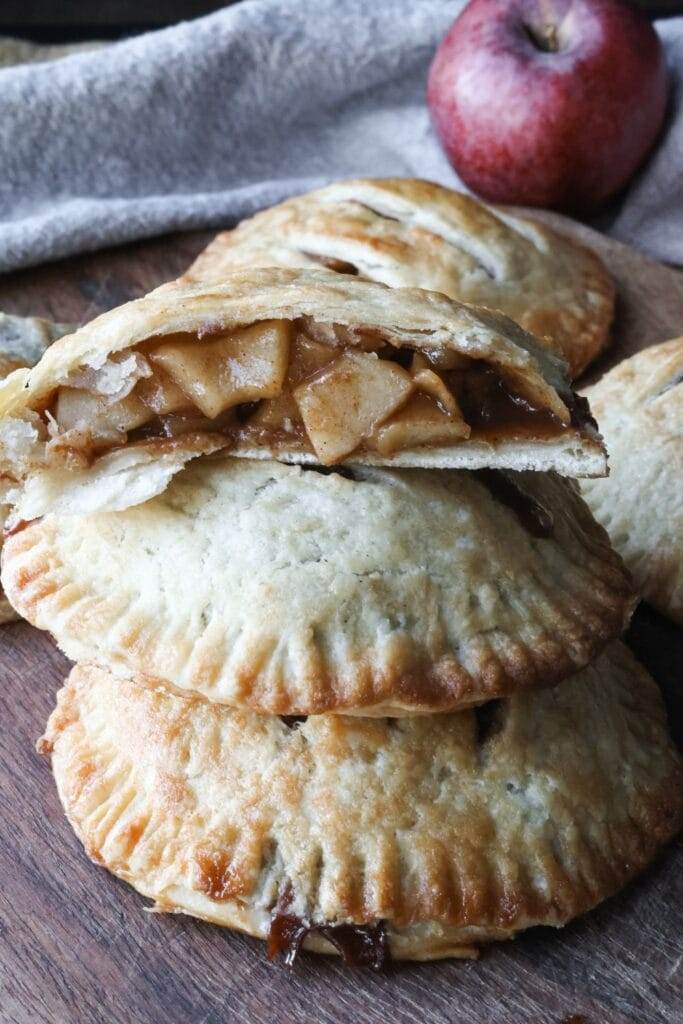 Close-up of a perfectly golden, flaky crust on a homemade apple hand pie, showing off the layers of buttery goodness