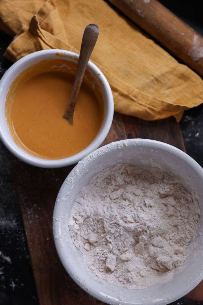 Flour, spices, and baking powder mixed together in a large bowl to start the pumpkin scone dough.