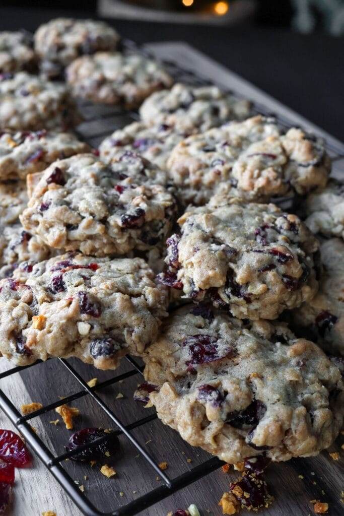 Freshly baked cranberry orange oatmeal cookies cooling on a wire rack